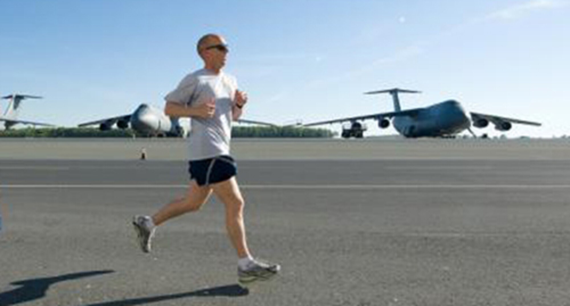 Master Sgt. Marshall Stafford, 436th Communications Squadron NCO in charge of Information Assurance, runs along the flightline during a Dover Air Force Base Warrior Run. Sergeant Stafford was selected as an alternate member of the Air Mobility Command Team participating in the 13th Annual U.S. Air Force Marathon Sept. 19 at Wright-Patterson Air Force Base, Ohio. (U.S. Air Force photo/ Jason Minto)