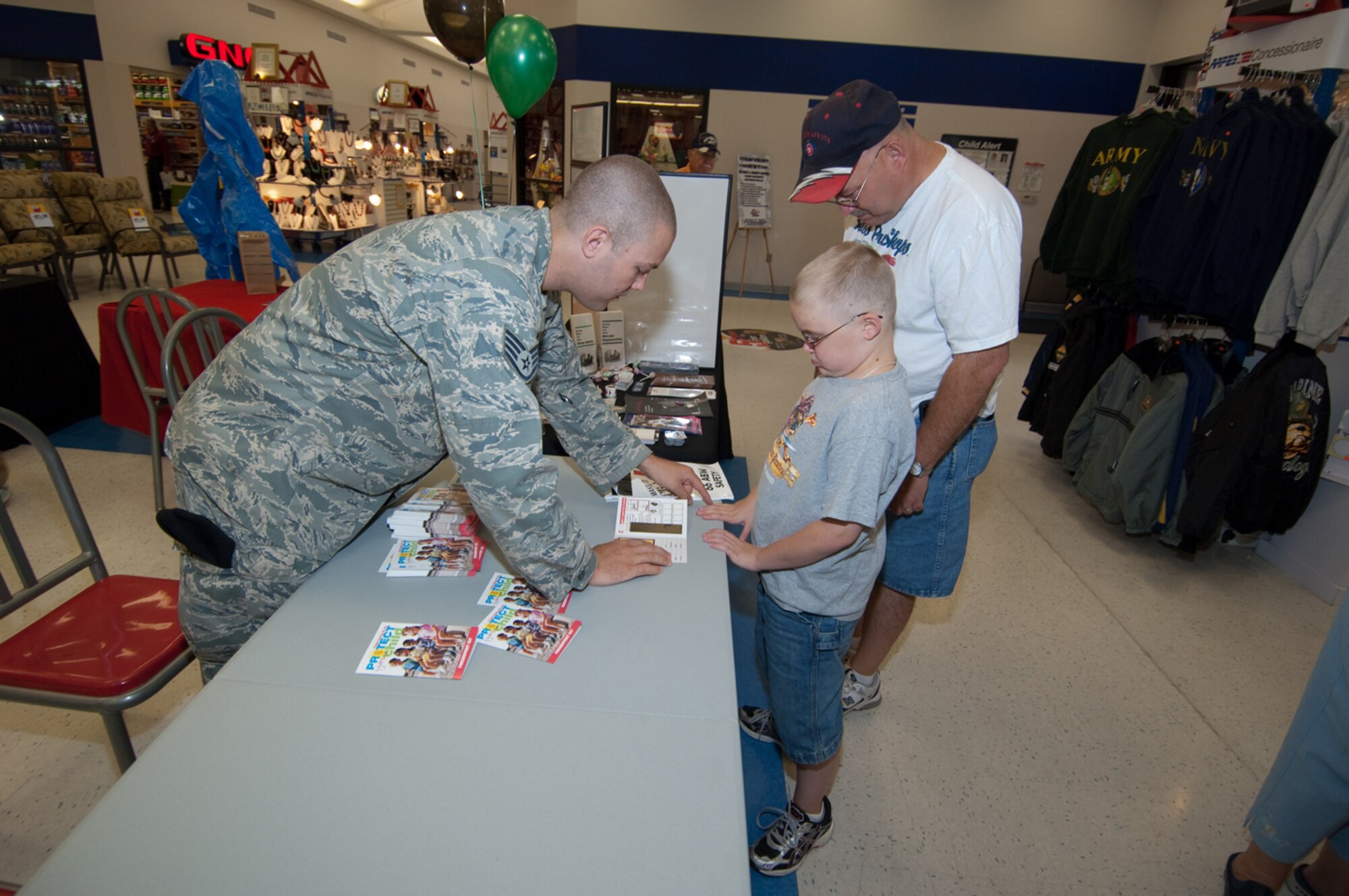 HANSCOM AIR FORCE BASE, Mass. –Staff Sgt. Michael Mandello, 66th Security Forces Squadron helps fingerprint a child with a child safety identification kit that he handed out to Hanscom Commissary patrons on Sept. 3, during a Safety Day exhibit. The 66th Air Base Wing Safety Office organized the Safety Day that included participation from the Fire Department, 66th Security Forces, Bioenvironmental and the AAFES Safety Office.  (U.S. Air Force photo by Rick Berry)