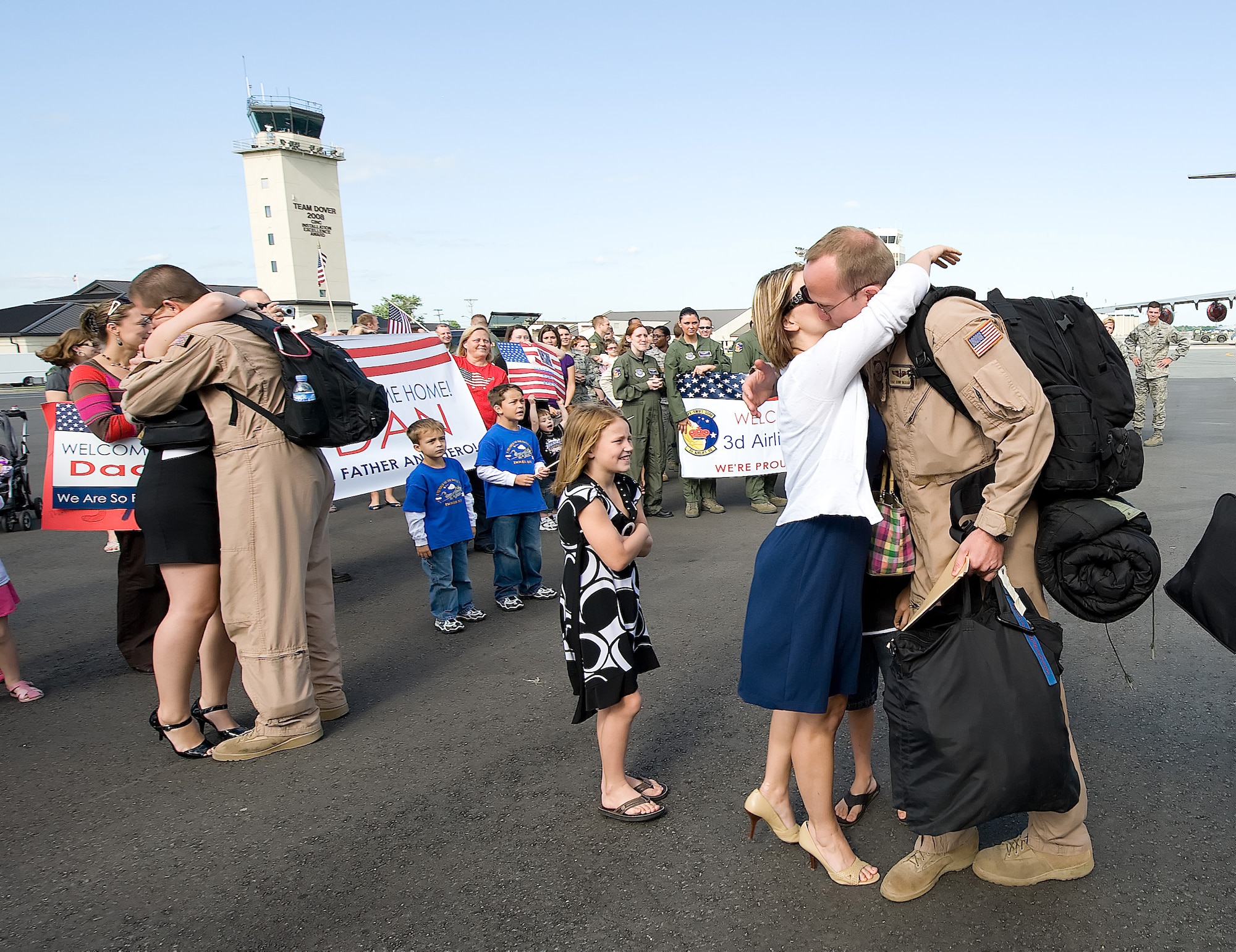 (On right) Tech. Sgt. Donny Washam, 3rd Airlift Squadron, embraces his wife Leslie after returning to Dover Air Force Base Sept. 2. Sergeant Washam and nearly 120 members of the 3rd AS deployed to Southwest Asia in April as the 816th Expeditionary  Airlift Squadron to provide combat airlift and airdrop, aeromedical evacuations, humanitarian relief and distinguished visitor movement in the U.S. Central Command area of responsibility. (U.S. Air Force photo/Jason Minto)