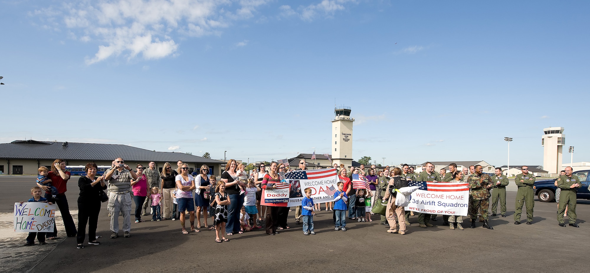 Family members and Team Dover Airmen gather to welcome members of the 3rd Airlift Squadron back to Dover Air Force Base Sept. 2. The 3rd AS deployed to Southwest Asia in April as the 816th Expeditionary  Airlift Squadron to provide combat airlift and airdrop, aeromedical evacuations, humanitarian relief and distinguished visitor movement in the U.S. Central Command area of responsibility. (U.S. Air Force photo/Jason Minto) 