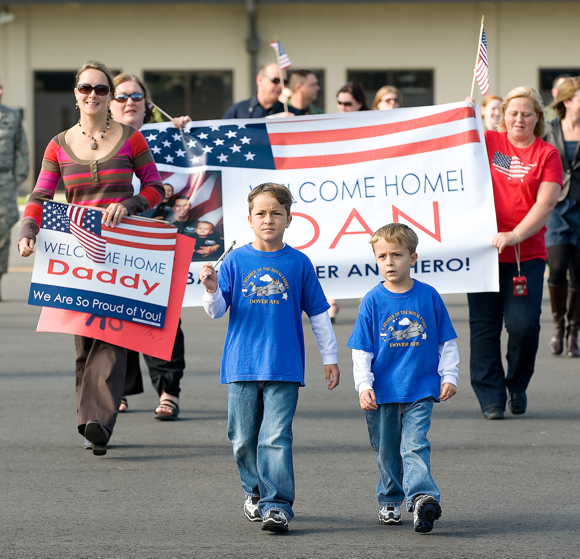 (From left) Therese Cooley and her sons Ty, 7, and Gavin, 5, family of Maj. Dan Cooley, 3rd Airlift Squadron assistant operations officer and aircraft commander, walk out to greet Major Cooley as he returned to Dover Air Force Base Sept. 2. Major Cooley and the nearly 120 members of the 3rd AS deployed to Southwest Asia in April as the 816th Expeditionary  Airlift Squadron to provide combat airlift and airdrop, aeromedical evacuations, humanitarian relief and distinguished visitor movement in the U.S. Central Command area of responsibility. (U.S. Air Force photo/Jason Minto) 