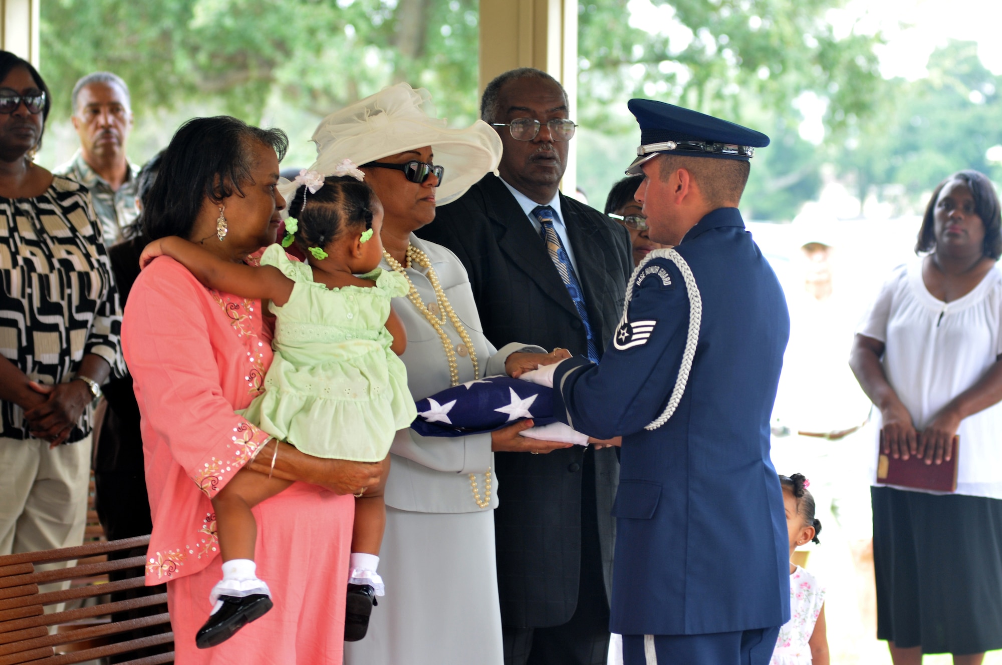 Staff Sgt. Jose Ramos, right, from the Keesler Honor Guard presents the flag to Rose Decatur at a Sept. 3 interment ceremony for her husband, Robert Decatur, at Biloxi National Cemetery. Mr. Decatur, who died Aug. 19 at the age of 88, was the first black pre-flight cadet to be sent to Keesler for basic training in 1943. He went on to become a Tuskegee Airman, judge, civil-rights lawyer and recipient of the Congressional Gold Medal.  (U.S. Air Force photo by Adam Bond)