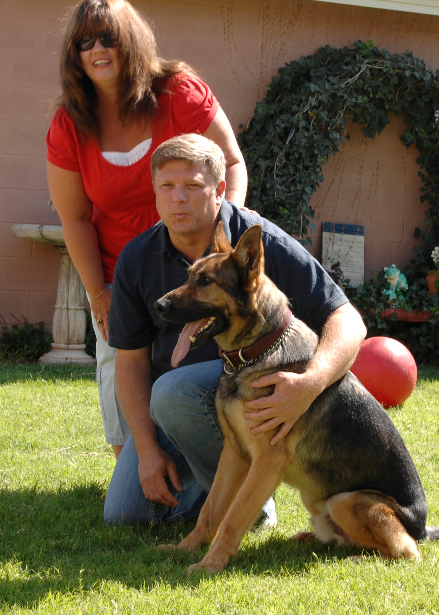 CANNON AIR FORCE BASE, N.M. -- Troy and Tonia Gilliard spend time in their backyard with Alex, their adopted former Military Working Dog. Mr. Gilliard is a former security forces dog handler who learned that Alex was available because of health issues. (U.S Air Force photo by Greg Allen)