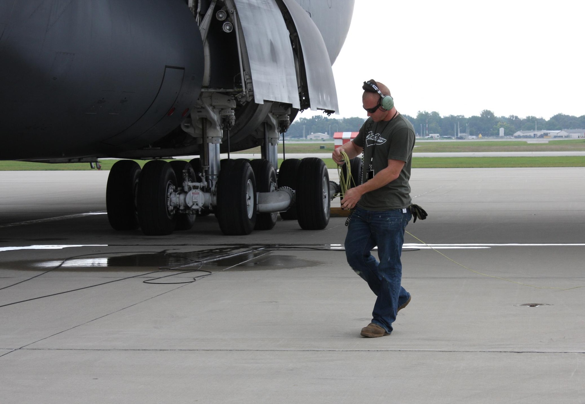 WRIGHT-PATTERSON AIR FORCE BASE, Ohio – Staff Sgt. Scott Bunch, 433rd Airlift Wing Maintenance Group crew chief, preps a C-5 Galaxy belonging to the 433rd AW for a morning training mission Sept. 8.  Forty one reservists from the 433rd AW Maintenance Group, Lackland Air Force Base, Texas, set up shop here Sept. 3 for a two-week stay to support two C-5s from their unit that are temporarily flying training missions here while their runway is closed for repairs.  (U. S. Air Force photo/Stacy Vaughn)