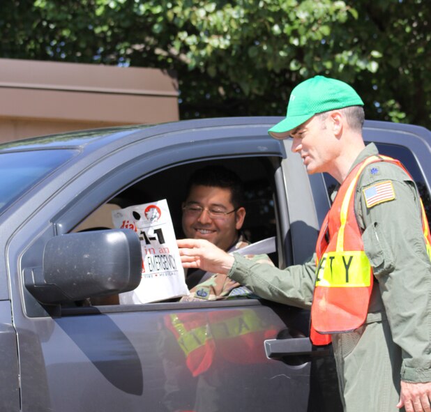 PITTSBURGH IAP ARS - Tech. Sgt. Jorge Alvarez receives a “dial 9-1-1 in an Emergency bag,” Sept 3, 2009, as 911th Airlift Wing Safety and Security personnel distribute brochures at a seat belt check point on base. (Photo by Master Sgt. Mark A. Winklosky)