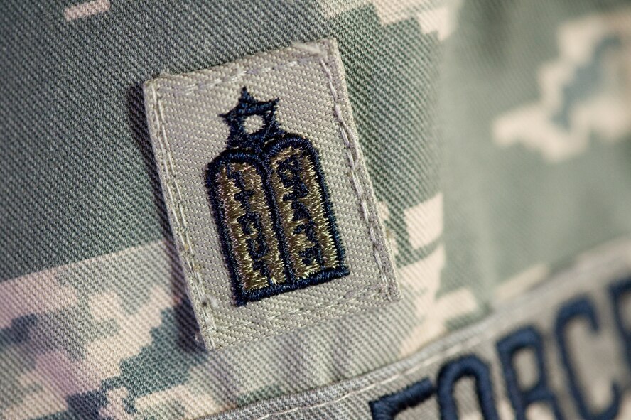 The Jewish chaplain badge embroidered with the ten-commandments, Hebrew lettering and the Jewish star on top is worn by U.S. Air Force Rabbi, Chaplain, Captain Sarah D. Schechter who leaded the evening le'il shabbat service on Friday, Sept. 4, 2009 at Lackland Air Force Base's Airmen Memorial Chapel. The more than 25 basic military trainees and other attendees participated in a religious education class, then Ma'ariv prayer service for the setting of the sun, followed by a meal provided by lay leaders supporting the service. Because of training schedules some ceremonies and events are earlier than traditionally held. By order of commanders, those who want to attend any or all religious services of their choosing are given full permission and opportunity to do so.  Chaplain, Captain Schechter is an Operation Iraqi Freedom veteran and considers her deployment there to be one of the highlights of her career. Schechter is the first woman rabbi in the U.S. Air Force. (U.S. Air Force photo/Lance Cheung)
