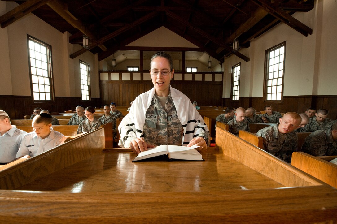 U.S. Air Force Rabbi, Chaplain, Captain Sarah D. Schechter (standing and wearing a tallit, prayer shawl) leads the evening le'il shabbat service on Friday, Sept. 4, 2009 at Lackland Air Force Base's Airmen Memorial Chapel. The more than 25 basic military trainees and other attendees participated in a religious education class, then Ma'ariv prayer service for the setting of the sun, followed by a meal provided by lay leaders supporting the service. Because of training schedules some ceremonies and events are earlier than traditionally held. By order of commanders, those who want to attend any or all religious services of their choosing are given full permission and opportunity to do so.  Chaplain, Captain Schechter is an Operation Iraqi Freedom veteran and considers her deployment there to be one of the highlights of her career. Schechter is the first woman rabbi in the U.S. Air Force. (U.S. Air Force photo/Lance Cheung)

