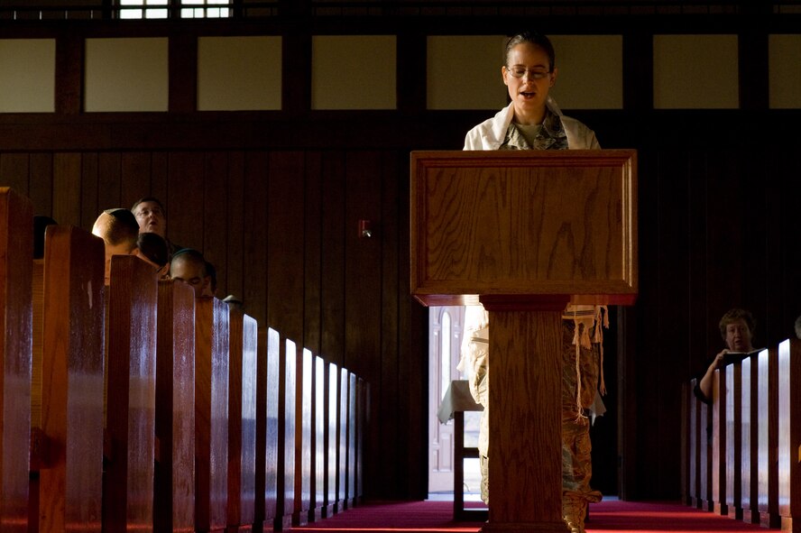 U.S. Air Force Rabbi, Chaplain, Captain Sarah D. Schechter (standing and wearing a tallit, prayer shawl) leads the evening le'il shabbat service using notes and a special edition siddur: "For Jewish personnel in the Armed Forces of the United States,"  on Friday, Sept. 4, 2009 at Lackland Air Force Base's Airmen Memorial Chapel. The more than 25 basic military trainees and other attendees participated in a religious education class, then Ma'ariv prayer service for the setting of the sun, followed by a meal provided by lay leaders supporting the service. Because of training schedules some ceremonies and events are earlier than traditionally held. By order of commanders, those who want to attend any or all religious services of their choosing are given full permission and opportunity to do so.  Chaplain, Captain Schechter is an Operation Iraqi Freedom veteran and considers her deployment there to be one of the highlights of her career. Schechter is the first woman rabbi in the U.S. Air Force. (U.S. Air Force photo/Lance Cheung)
