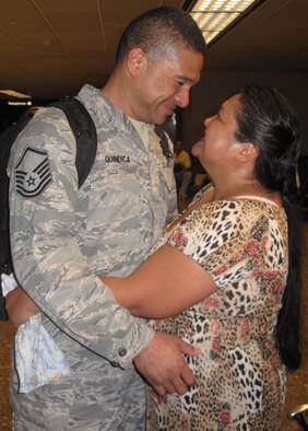 Air Force Reserve Master Sgt Randall Quindica savors the moment with his wife,  Ponciana, after seeing her for the first time since deploying to Iraq in May.  Sergeant Quindica and 14 of his fellow aerial porters from the 624th Regional Support Group, Hickam Air Force Base, Hawaii, arrived at Honolulu airport September 8 following a four-month deployment to Joint Base Balad.  A total of 25 Airmen from the Air Force Reserve unit are coming home this week. (Photo by Master Sgt Janet Hudson)