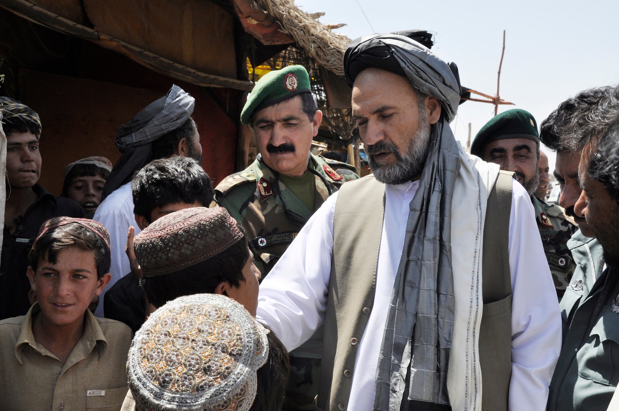 Gov. Mohammad Ashraf Naseri questions children during his Aug. 24, 2009, trip to Sha Joy district to discuss issues and concerns with village elders in the Zabul Province, Afghanistan. American servicemembers of the Provincial Reconstruction Team-Zabul provided transportation and security. (U.S. Army photo/Staff Sgt. Marcos Alices)