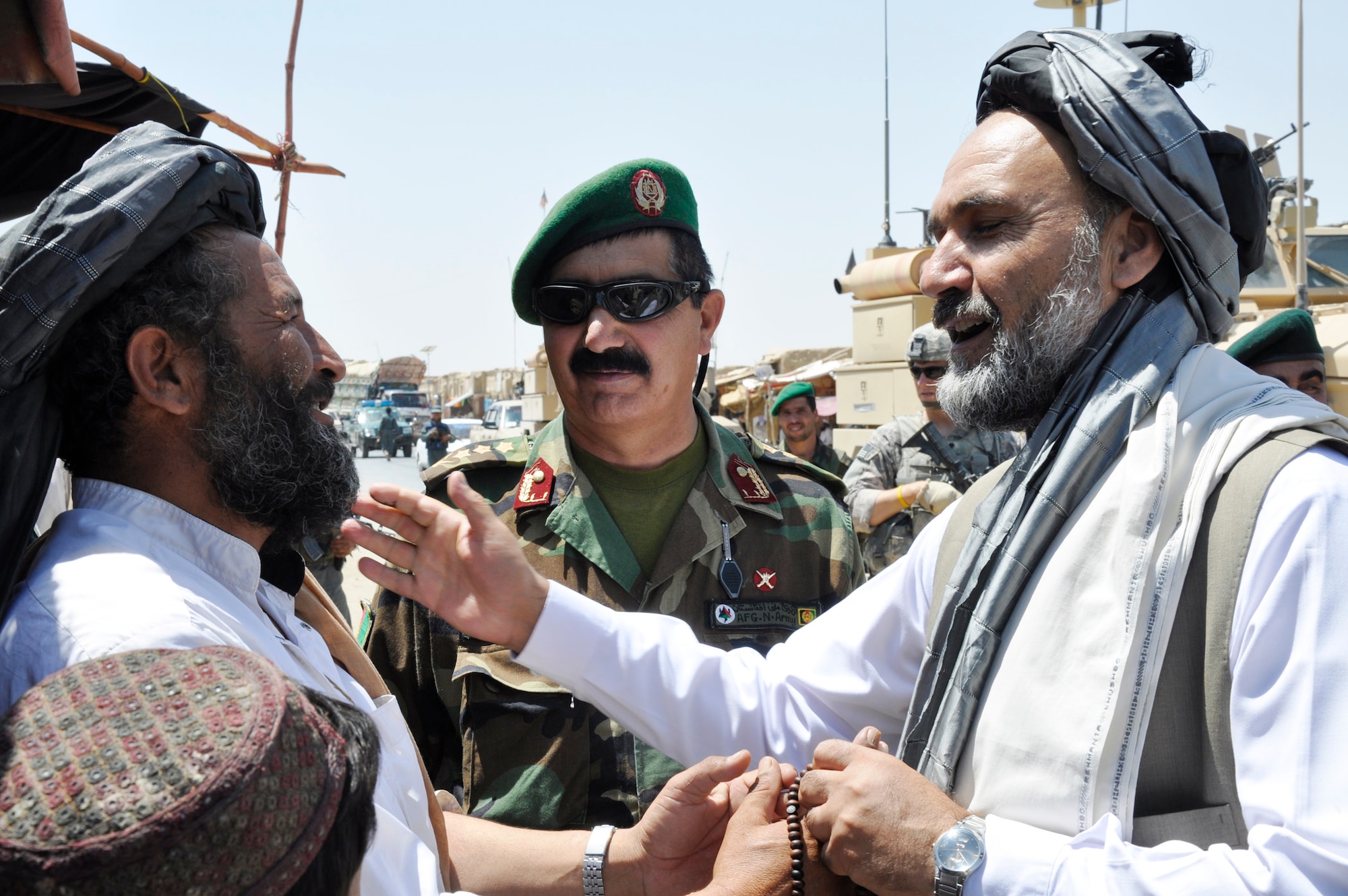 Gov. Mohammad Ashraf Naseri meets and greets locals during his Aug. 24, 2009, trip to Sha Joy district to discuss issues and concerns with village elders in the Zabul Province, Afghanistan. American servicemembers of the Provincial Reconstruction Team-Zabul provided transportation and security, and is a civil and military organization that brings reconstruction, development, governance and security to the province. (U.S. Army photo/Staff Sgt. Marcos Alices)
