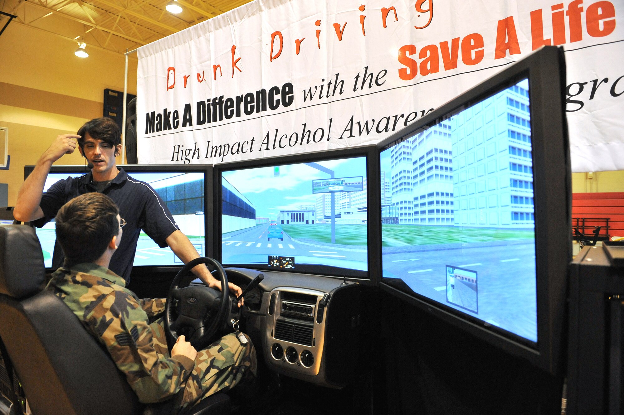 SHAW AIR FORCE BASE, S.C. -- Brian Beldyga, founder of the Save-A-Life Tour, instructs Senior Airman Daniel Burns-McKernan, 20th Operations Support Squadron aircrew flight equipment technician, on a drinking and driving simulator, Sept. 8. The simulator is part of a national high-impact alcohol awareness program that explains how some drivers have driven drunk as many as over 400 times before getting pulled over. (U.S. Air Force photo/Senior Airman McDowell)