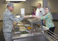 MINOT AIR FORCE BASE, N.D. -- Chief Master Sgt. Martin K. Smith, 5th Bomb Wing command chief, serves a fellow member of the Team Minot community lunch at the Dakota Dining Facility Sept. 1 here. The focus of their involvement was to get to know their Airmen and understand the challenges Airmen face in their respective jobs. (U.S. Air Force Photo by Airman 1st Class Benjamin Stratton)