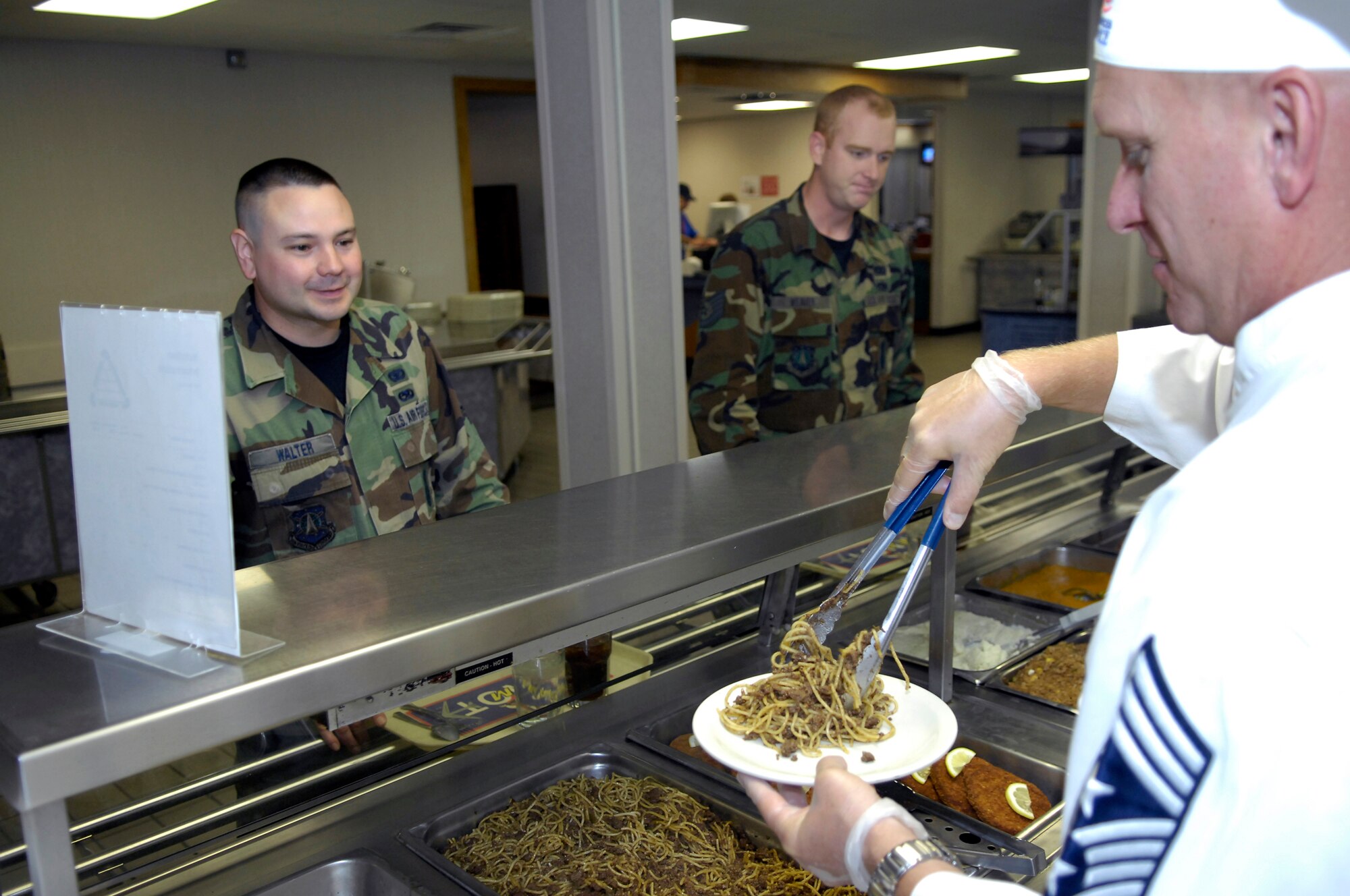 MINOT AIR FORCE BASE, N.D. -- Chief Master Sgt. Gregory M. Fleming, 91st Missile Wing command chief, serves a fellow member of the Team Minot community lunch at the Dakota Inn Dining Facility Sept. 1 here. The focus of their involvement was to get to know their Airmen and understand the challenges Airmen face in their respective jobs. (U.S. Air Force Photo by Airman 1st Class Benjamin Stratton)