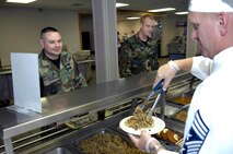MINOT AIR FORCE BASE, N.D. -- Chief Master Sgt. Gregory M. Fleming, 91st Missile Wing command chief, serves a fellow member of the Team Minot community lunch at the Dakota Inn Dining Facility Sept. 1 here. The focus of their involvement was to get to know their Airmen and understand the challenges Airmen face in their respective jobs. (U.S. Air Force Photo by Airman 1st Class Benjamin Stratton)