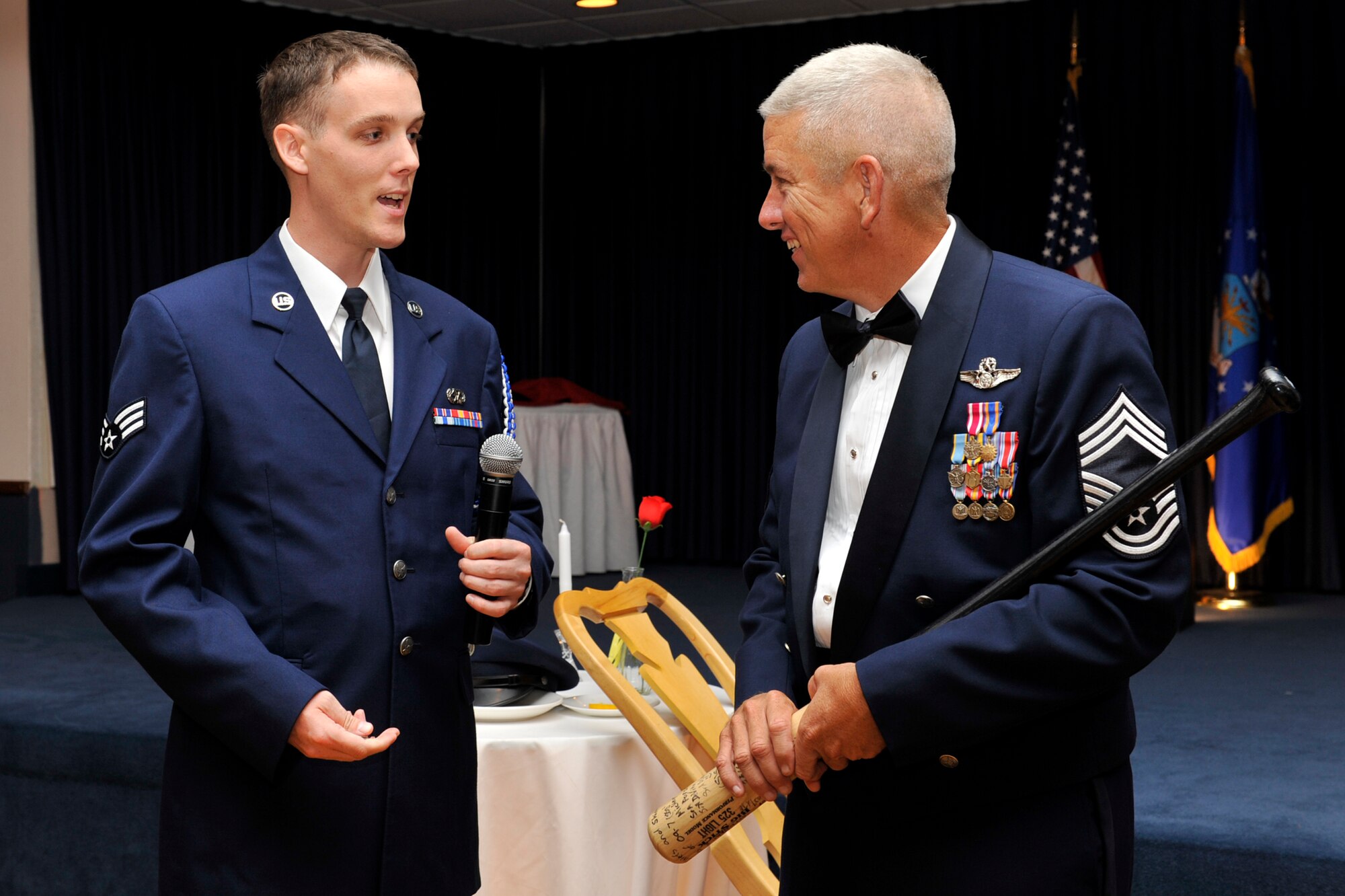 Senior Airman Shawn Pantall, 19th Civil Engineer Squadron precision measurement equipment laboratory technician, Airman Leadership School 09-7 class leader presents Chief Master Sgt. John J. Spillane IV, 19th Operations Support Squadron superintendent, with the chief mentor gift at Hangar 1080 Sept. 3. The baseball bat gift was signed by the entire 09-7 ALS class. (U.S. Air Force photo by Airman Lausanne Pacheco)