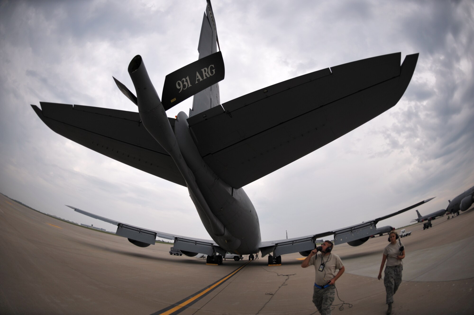 Rain clouds loom as Tech. Sgt. John Grindstaff and Senior Airman Candice Dodds help prepare a KC-135 Stratotanker at McConnell Air Force Base, Kan., for a refueling mission.  Nearly six inches of rain had fallen at the base in about 24 hours by Sept. 9, with more rain in the forecast for every day through Sept. 18. Sergeant Grindstaff and Airman Dodds are Reserve maintenance crew chiefs assigned to the 931st Air Refueling Group at McConnell. (U.S. Air Force photo/Tech. Sgt. Jason Schaap)