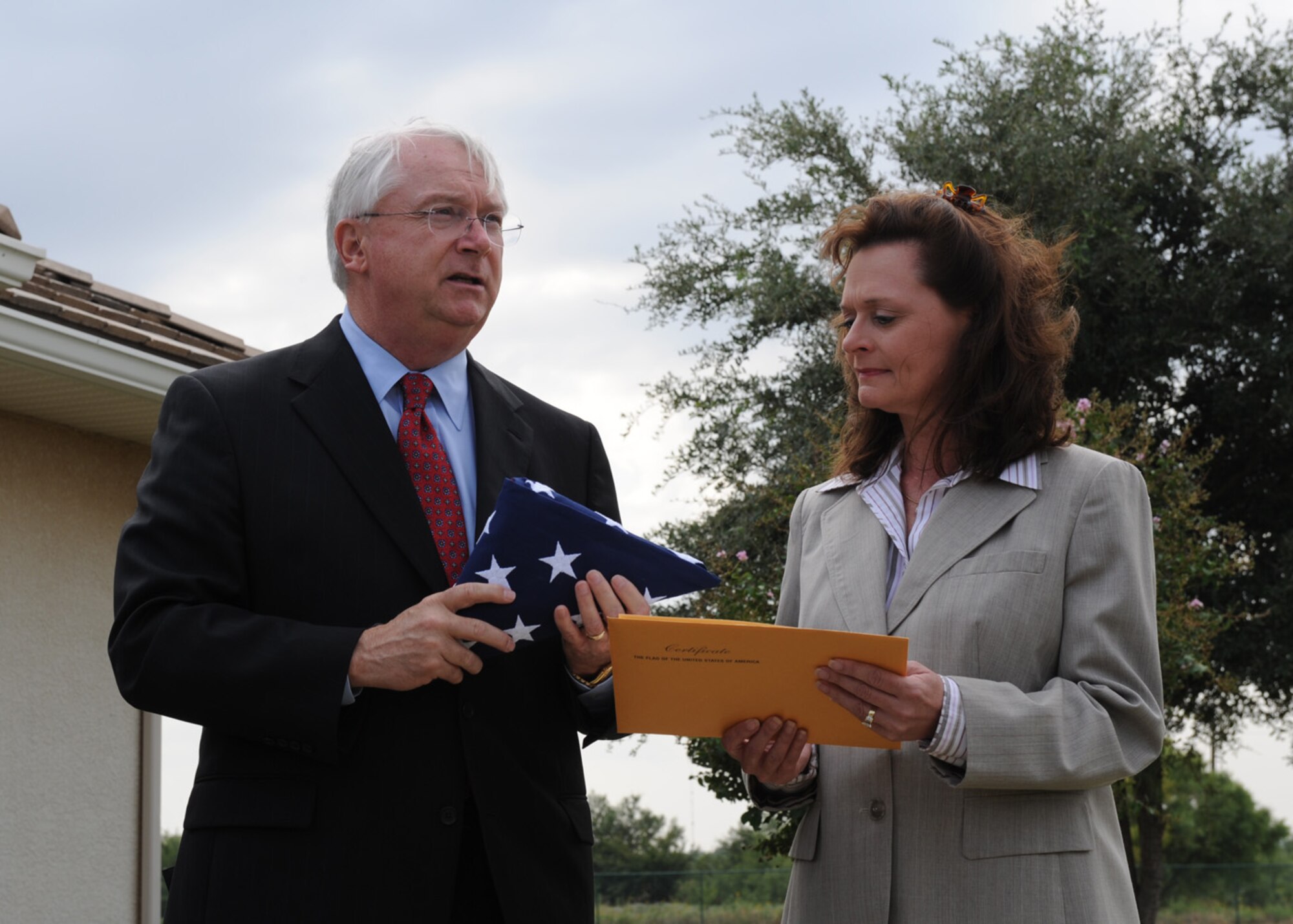 DYESS AIR FORCE BASE, Texas -- Texas Congressman Randy Neugebauer presents the National Multifamily Customer Service Award to Sandy Nichols Quail Hollow community director Sept. 4. Quail Hallow received the award for achieving the highest level of quality and service, as rated by the residents.

