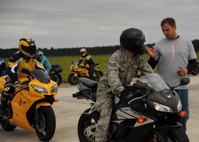 Tech. Sgt. Nelson Irizarry speaks to a Sport Bike Course student on Charleston AFB's flightline Sept. 2. The motorcycle course typically has 10-12 new riders each month. Sergeant Irizarry is an electrical and environmental specialist with the 315th Aircraft Maintenance Squadron. (U.S. Air Force photo/Senior Airman Katie Gieratz)(RELEASED)  
