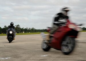 Airman Daniel Clarke performs a turn during the Sport Bike Course on Charleston AFB's flightline Sept. 2. The motorcycle course teaches riders how to safely negotiate turns, brake, accelerate, throttle control, body position and lean angles. Airman Clarke is an aircrew flight equipment journeyman with the 437th Operations Support Squadron. (U.S. Air Force photo/Senior Airman Katie Gieratz) (RELEASED)

