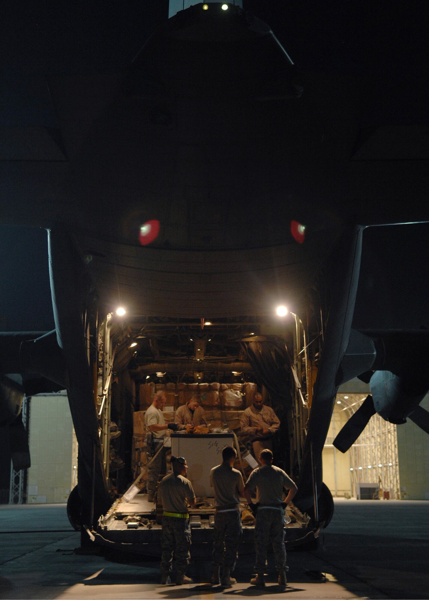 JOINT BASE BALAD, Iraq -- Airmen of the 332nd Expeditionary Logistics Readiness Squadron check the weight and balance of cargo aboard a C-130 Hercules at the South Ramp here Aug. 26. The 332nd ELRS handle baggage pallets, general cargo, special handling cargo, rolling stock and aerospace ground equipment. (U.S. Air Force photo/Senior Airman Christopher Hubenthal)
