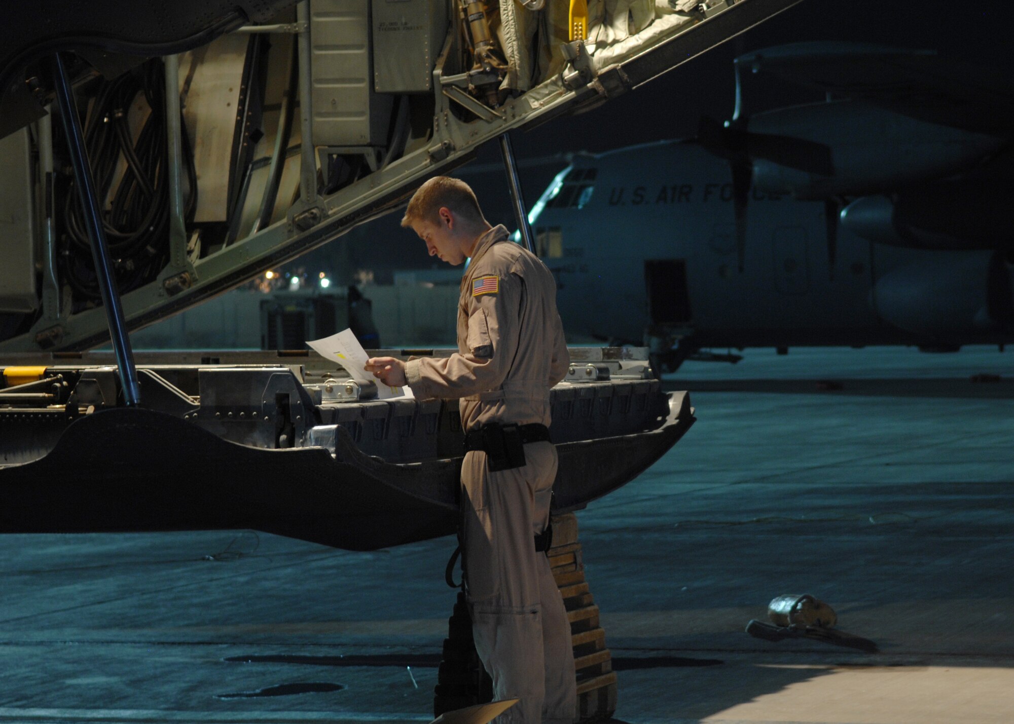 JOINT BASE BALAD, Iraq -- Airman Anthony Bliss, of the 777th Expeditionary Airlift Squadron, makes preparations for cargo to be loaded on a C-130 Hercules at the South Ramp here Aug. 26. (U.S. Air Force photo/Senior Airman Christopher Hubenthal)