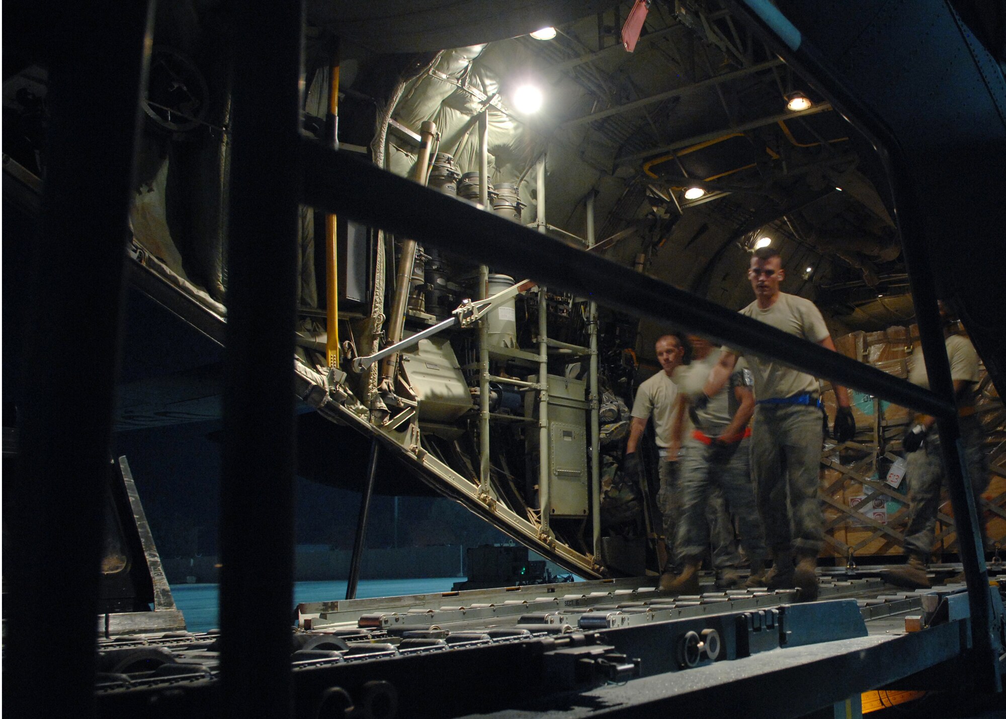 JOINT BASE BALAD, Iraq -- Airmen of the 332nd Expeditionary Logistics Readiness Squadron load cargo pallets on a C-130 Hercules at the South Ramp here Aug. 26. The 332nd ELRS handle baggage pallets, general cargo, special handling cargo, rolling stock and aerospace ground equipment. (U.S. Air Force photo/Senior Airman Christopher Hubenthal)