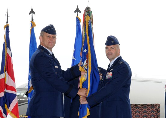 RAF MILDENHALL, England – Col. Chad T. Manske, right, receives the 100th Air Refueling Wing guidon from Lt. Gen. Frank Gorenc, Third Air Force Commander, as he takes command of the wing during a ceremony in hangar 814, Sept. 9, 2009. Outgoing Commander Brig. Gen. Eden J. Murrie will be the next Special Assistant to the vice chief of staff at Headquarters U.S. Air Force, Washington D.C. (U.S. Air Force photo/ Staff Sgt. Jerry Fleshman)