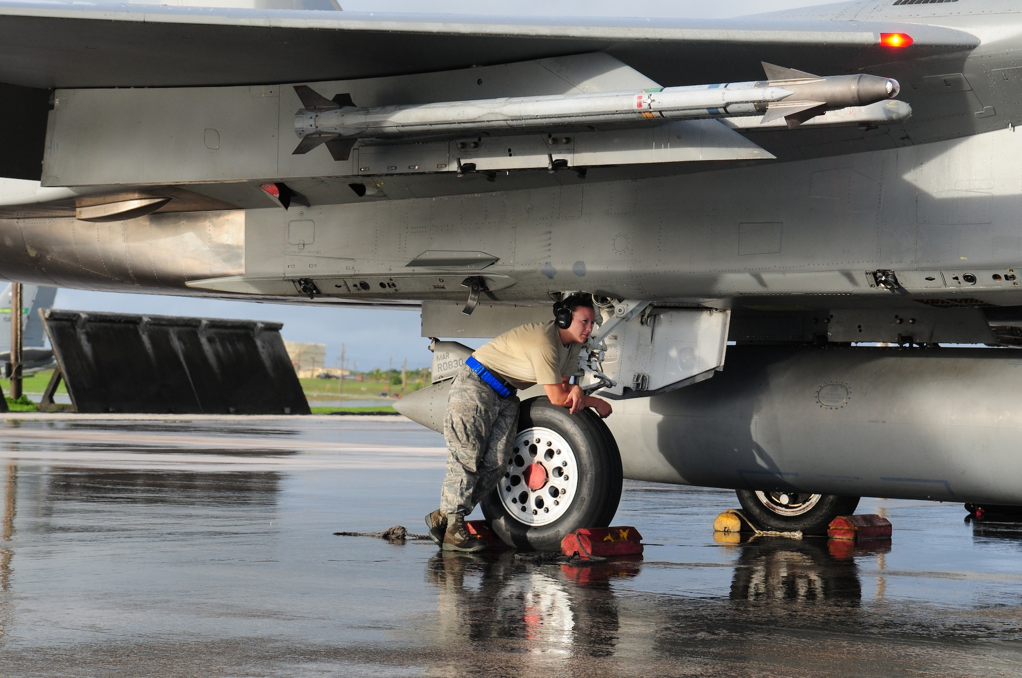 Staff Sgt. Kayla McIvor, a 67th Aircraft Maintenance Unit repair and reclamation craftsman deployed to Andersen Air Force Base, Guam, waits for word to pull chalks on an F-15. (U.S. Air Force Photo/Tech. Sgt. Mike Tateishi)