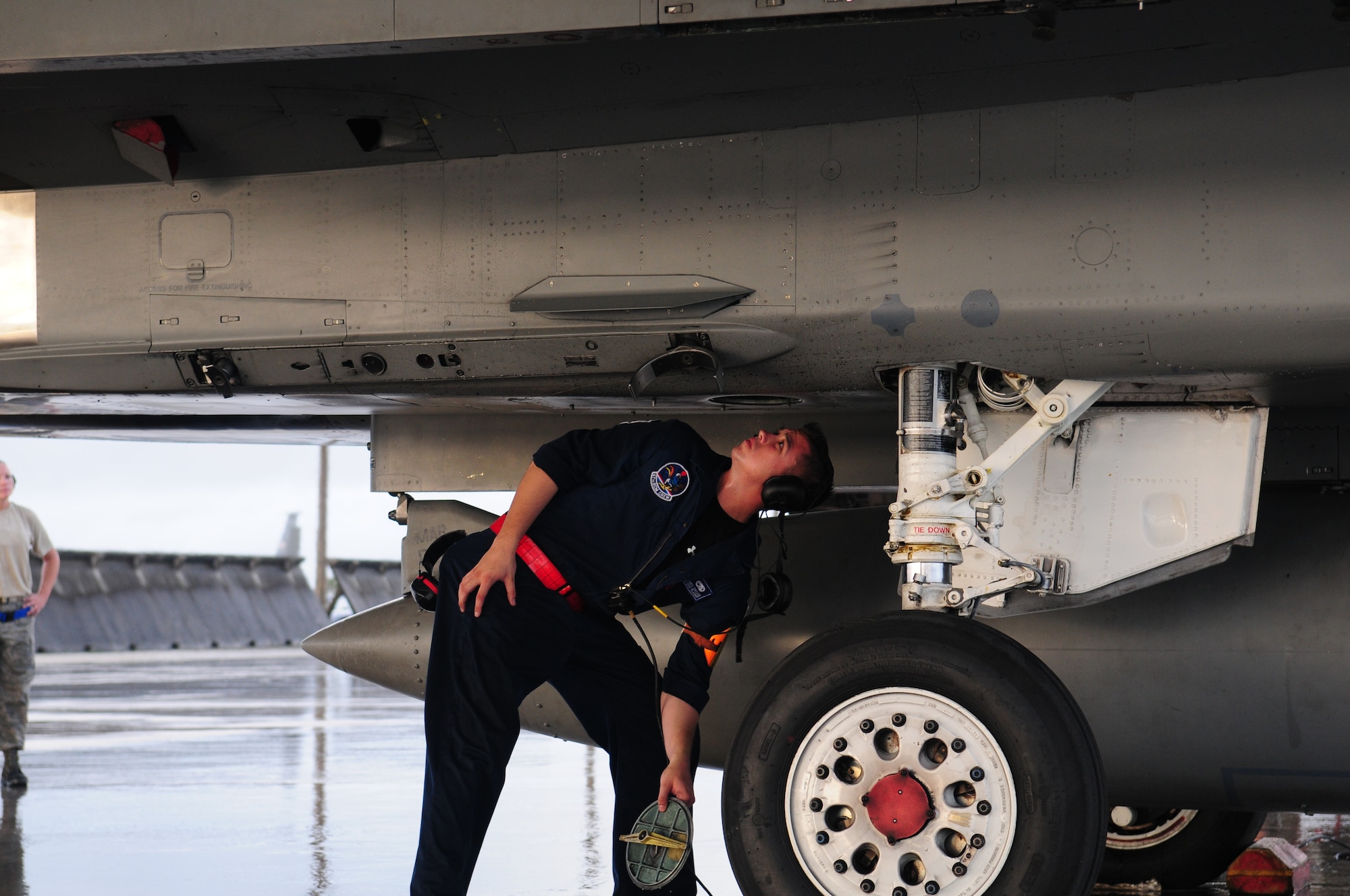 Airman 1st Class Dennis Crocker, a 67th Fighter Squadron crew chief, examines a Kadena F-15 while deployed to Andersen Air Force Base, Guam. 
(U.S. Air Force Photo/Tech. Sgt. Mike Tateishi)