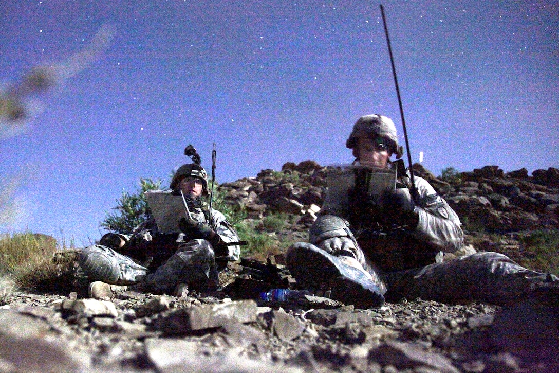 U.S. Army Cpt. Gary McDonald, left, and 1st Lt. Kevin Harris look at a topographical map to verify their location during a night patrol in the mountains near Sar Howza in Paktika province, Afghanistan, Sept. 2, 2009. McDonald and Harris are assigned to the 1st Squadron, 40th Cavalry Regiment.