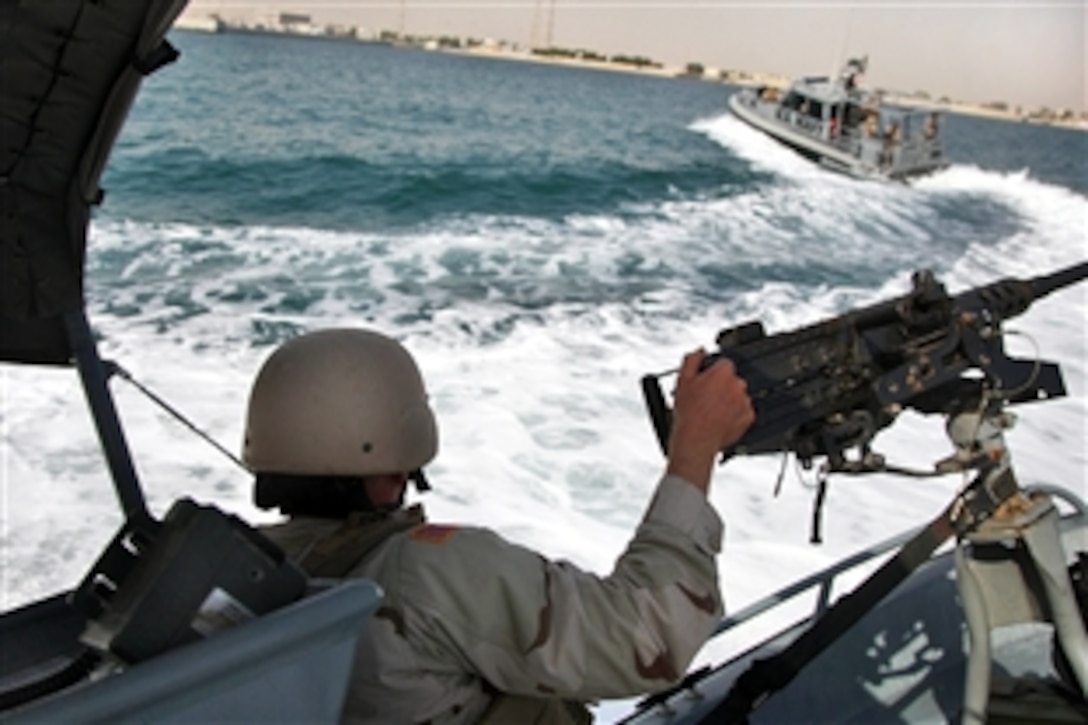 U.S. Coast Guard Petty Officer 3rd Class Chris Curran braces himself aboard a transportable security boat during vessel tactics with the U.S. Navy Maritime Expeditionary Security Squadron 5 near Kuwaiti Naval Base, Sept. 4, 2009. Curran is a machinery technician assigned to Port Security Unit 301.
