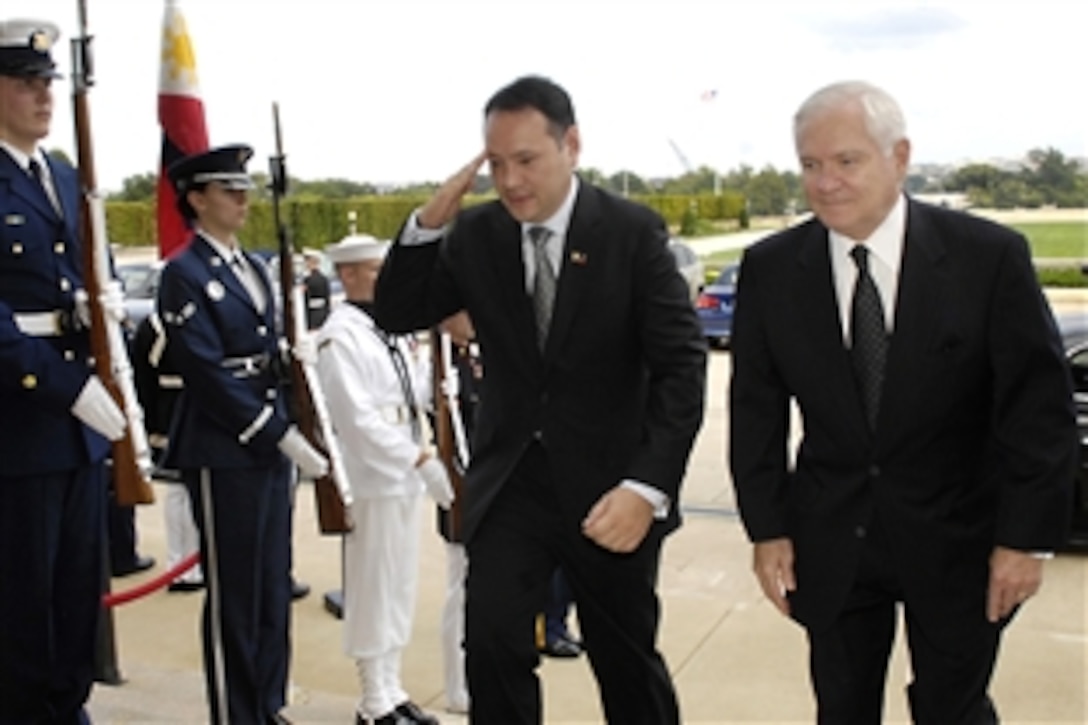 Defense Secretary Robert M. Gates, right, escorts Phillipine Secretary of National Defense Gilberto Teodoro Jr. through an honor cordon into the Pentagon, Sept. 9, 2009, to discuss bilateral issues.