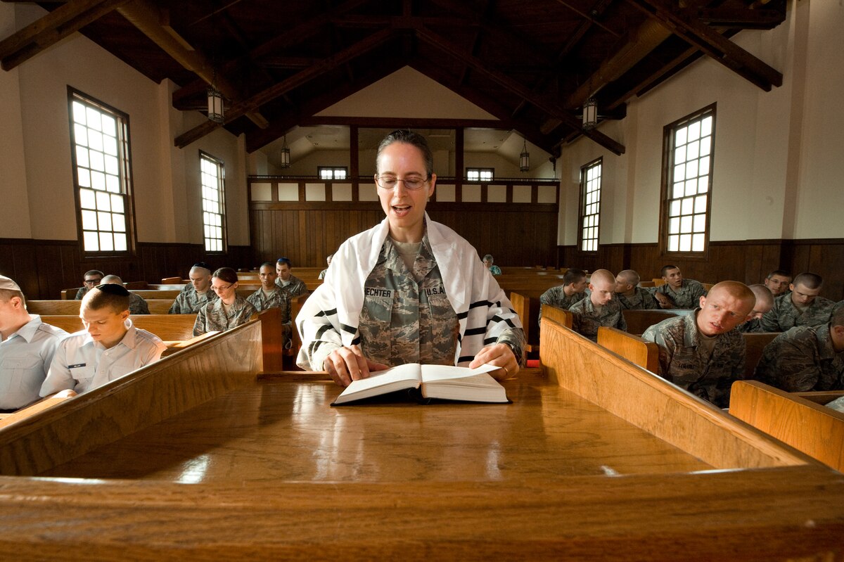U.S. Air Force Rabbi, Chaplain, Captain Sarah D. Schechter (standing and wearing a tallit, prayer shawl) leads the evening le'il shabbat service on Friday, Sept. 4, 2009 at Lackland Air Force Base's Airmen Memorial Chapel. The more than 25 basic military trainees and other attendees participated in a religious education class, then Ma'ariv prayer service for the setting of the sun, followed by a meal provided by lay leaders supporting the service. Because of training schedules some ceremonies and events are earlier than traditionally held. By order of commanders, those who want to attend any or all religious services of their choosing are given full permission and opportunity to do so.  Chaplain, Captain Schechter is an Operation Iraqi Freedom veteran and considers her deployment there to be one of the highlights of her career. Schechter is the first woman rabbi in the U.S. Air Force. (U.S. Air Force photo/Lance Cheung)

