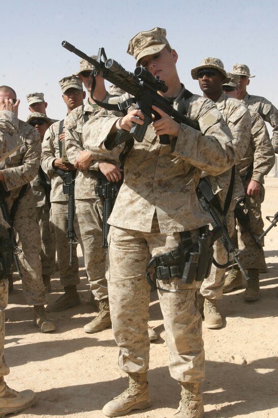 Lance Cpl. Brittany Potter, an administrative clerk with Marine Tactical Electronic Warfare Squadron 4, instructs Marines with Marine Fighter Attack Squadron 112 on speed reloading their weapons aboard Al Asad Air Base, Iraq, Sept. 10, 2009. The unit spent the time they weren’t in flight protecting convoys from hazards of the road, training quick reaction forces from other units, holding live-fire ranges and participating in security operations.
