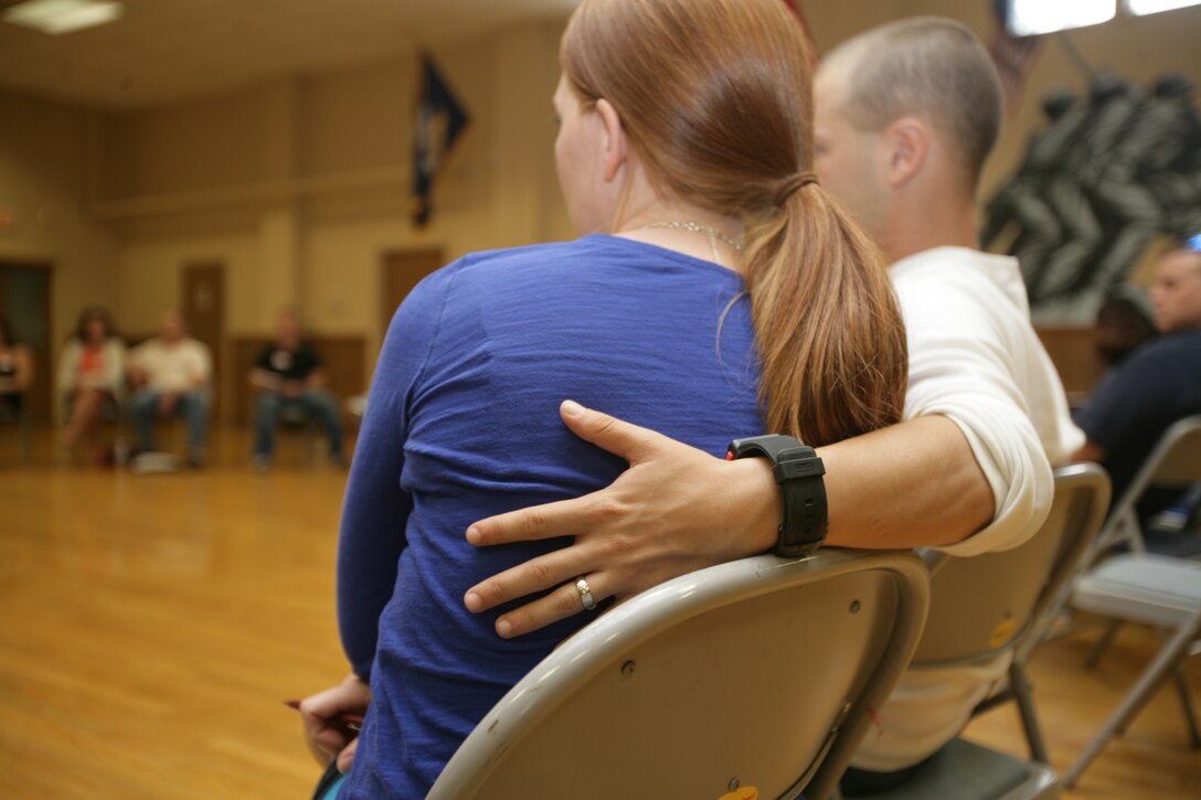 Sgt. Daniel Passman holds his wife during a marriage enrichment seminar held for the couples from the 26 Marine Expeditionary Unit at the Jacksonville USO, Sept. 10.