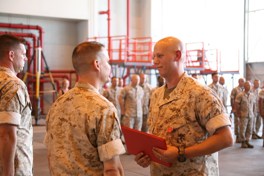Capt. Jason N. Dale, a forward air controller with Marine Aerial Refueler Transport Squadron-252, is awarded a Bronze Star with a combat distinguishing device by Marine Aircraft Group 14 commanding officer Col. Russell A. C. Sanborn during a ceremony conducted in VMGR-252’s hangar, Sept. 9. Dale was awarded his Bronze Star for participating in various combat operations in Operation Azada Wosa while deployed to the Gamsir District, Helmand Province, Afghanistan.