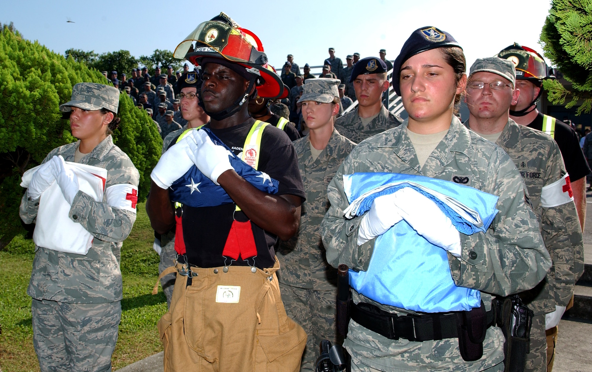 Kadena Airmen prepare to post the flags before Taps begins during the 9/11 memorial ceremony near the wing building here. The ceremony acknowledged those who risked their lives to save the victims of the tragic events of September 11, 2001. The ceremony also paid tribute to the men and women of the U.S. Armed Forces who have served in the military whether deployed or at home station since these events. (U.S. Air Force photo/Tech. Sgt. Reynaldo Ramon) 

