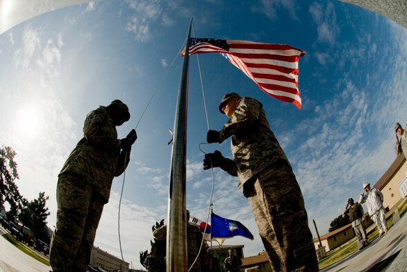 Senior Airman Danielle Todman and Airman 1st Class Kyle Detwiler post the colors during the September 11 Patriot Day Ceremony Sept. 11 at Kunsan Air Base, Republic of Korea. The ceremony is Kunsan's way of acknowledging the courageous firefighters, police officers, emergency responders and others who risked their lives to save the victims of the tragic events of September 11, 2001. The ceremony also paid tribute to the men and women of the U.S. Armed Forces who have served in the military whether deployed or at home station since these events. (U.S. Air Force photo/Senior Airman Jonathan Steffen) 