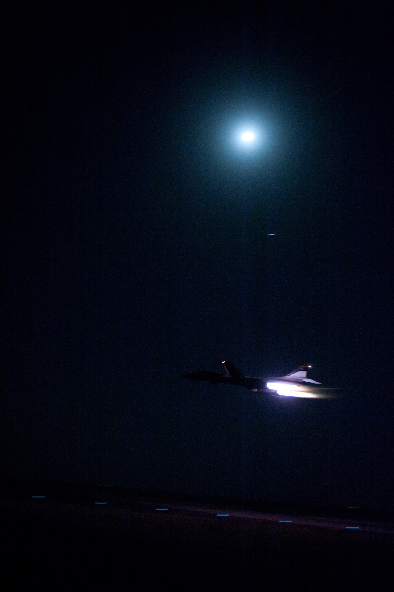 A B-1B Lancer aircrew from the 37th Expeditionary Bomber Squadron takes off during a moonlit night on a sortie, Sept. 3, in Southwest Asia. Carrying the largest payload of both guided and unguided weapons in the Air Force inventory, the multi-mission B-1 is the backbone of America's long-range bomber force. It can rapidly deliver massive quantities of precision and non-precision weapons against any adversary, anywhere in the world, at any time. The aircrew is deployed from Ellsworth Air Force Base, S.D. in support of Operations Iraqi and Enduring Freedom. (U.S. Air Force photo/Staff Sgt. Robert Barney)