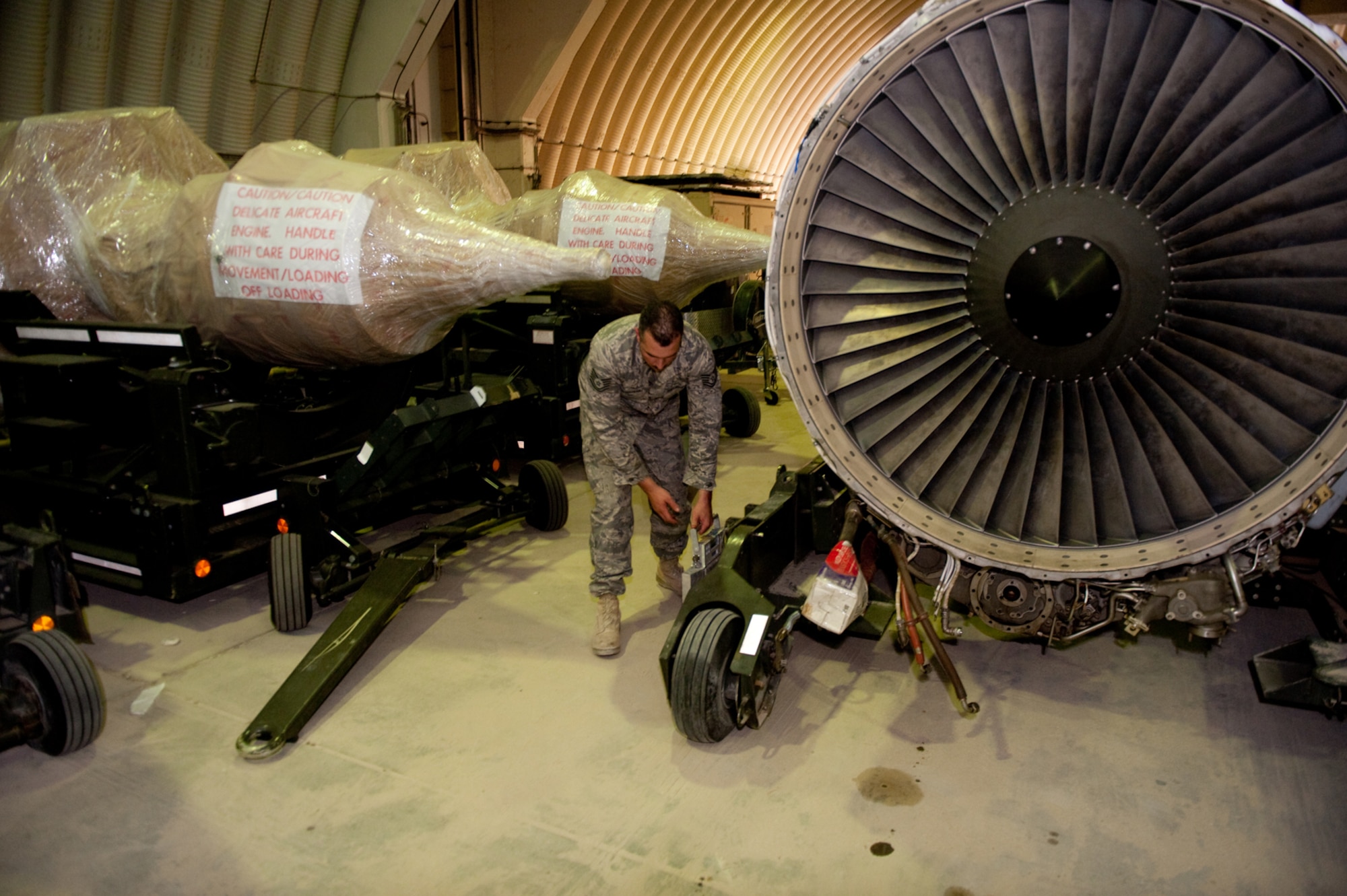 Tech. Sgt. Scott Marchesseault, 379th Maintenance Operations Squadron base engine manager, weighs a jet engine to ensure accurate shipping weight and balance, Sept. 8, in Southwest Asia. Sergeant Marchesseault helps track and manage jet engines, enabling local aircraft to accomplish missions in support of Operations Iraqi and Enduring Freedom. (U.S. Air Force photo/Staff Sgt. Robert Barney) 