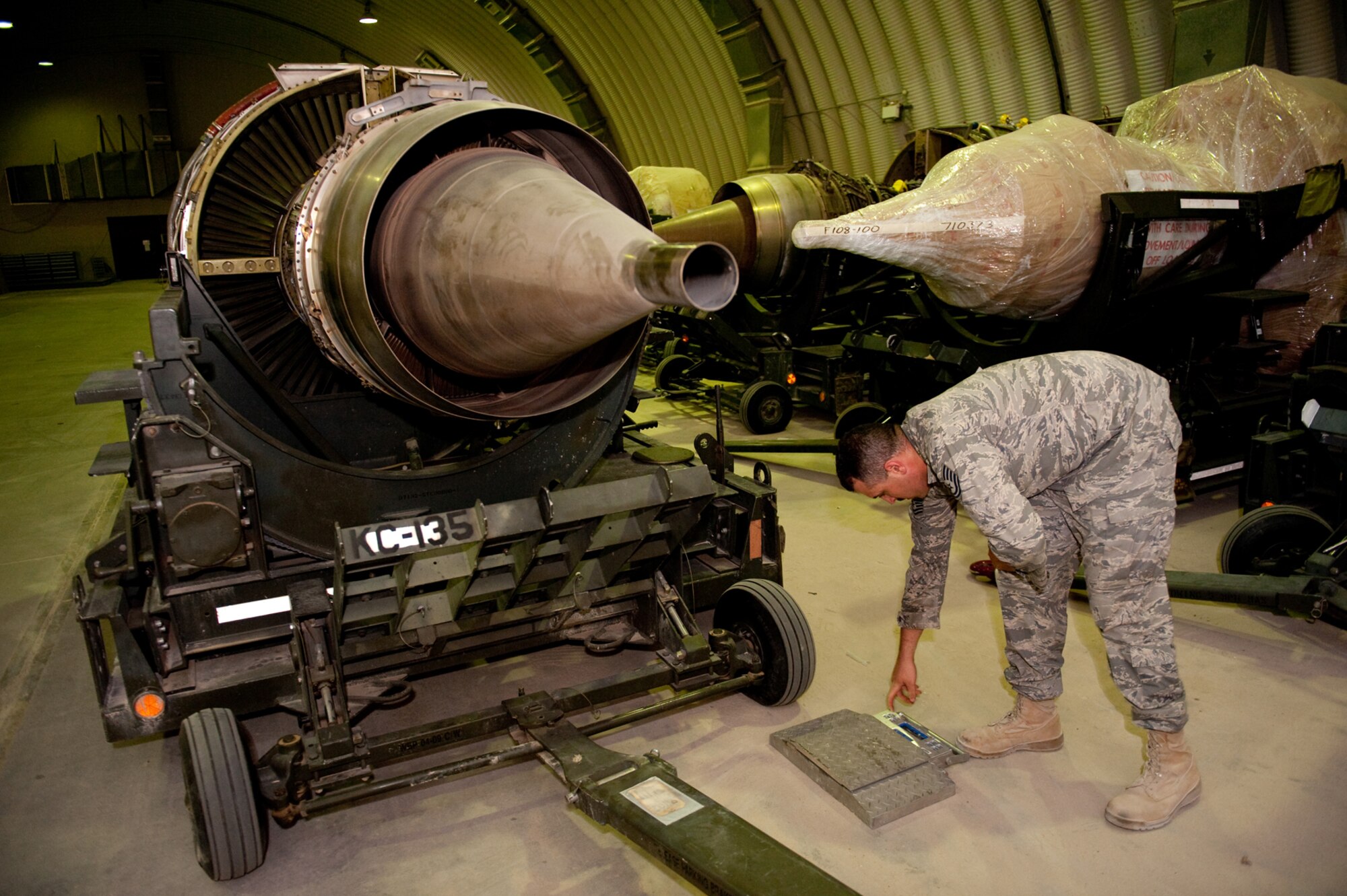 Tech. Sgt. Scott Marchesseault, 379th Expeditionary Maintenance Operations Squadron base engine manager, weighs a jet engine to ensure accurate shipping weight and balance, Sept. 8. Sergeant Marchesseault helps track and manage jet engines, enabling local aircraft to accomplish missions in support of Operations Iraqi and Enduring Freedom. (U.S. Air Force photo/Staff Sgt. Robert Barney) 