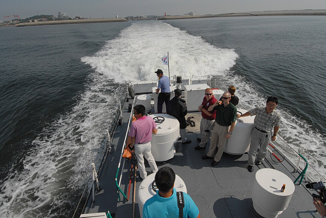 KUNSAN AIR BASE, Republic of Korea -- Korean and American members who attended the Joint Maritime Threat Working Group ride on a Korean Coast Guard patrol boat along the Gunsan coastline as part of the two-day working group meeting Sept. 3. The Joint Maritime Threat Working Group consists of Korean and American law enforcement agencies who work together to share information and capabilities on maritime threats.  (U.S. Air Force photo/Senior Airman Roy Lynch)