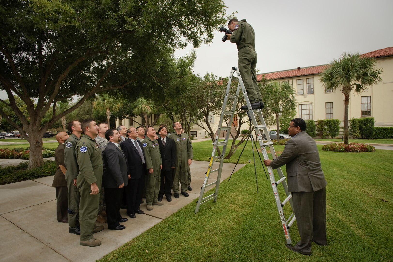 Tech. Sgt. Matt Hannen (ladder), Air Force Photojournalist assigned to Torch Magazine, Headquarters Air Education and Training Command, coordinates a photograph of Headquarters Safety Directorate staff members for a marketing poster themed "Mishap Prevention Starts Here" for distribution command-wide, and throughout the Air Force. (U.S. Air Force photo/Steve Thurow)