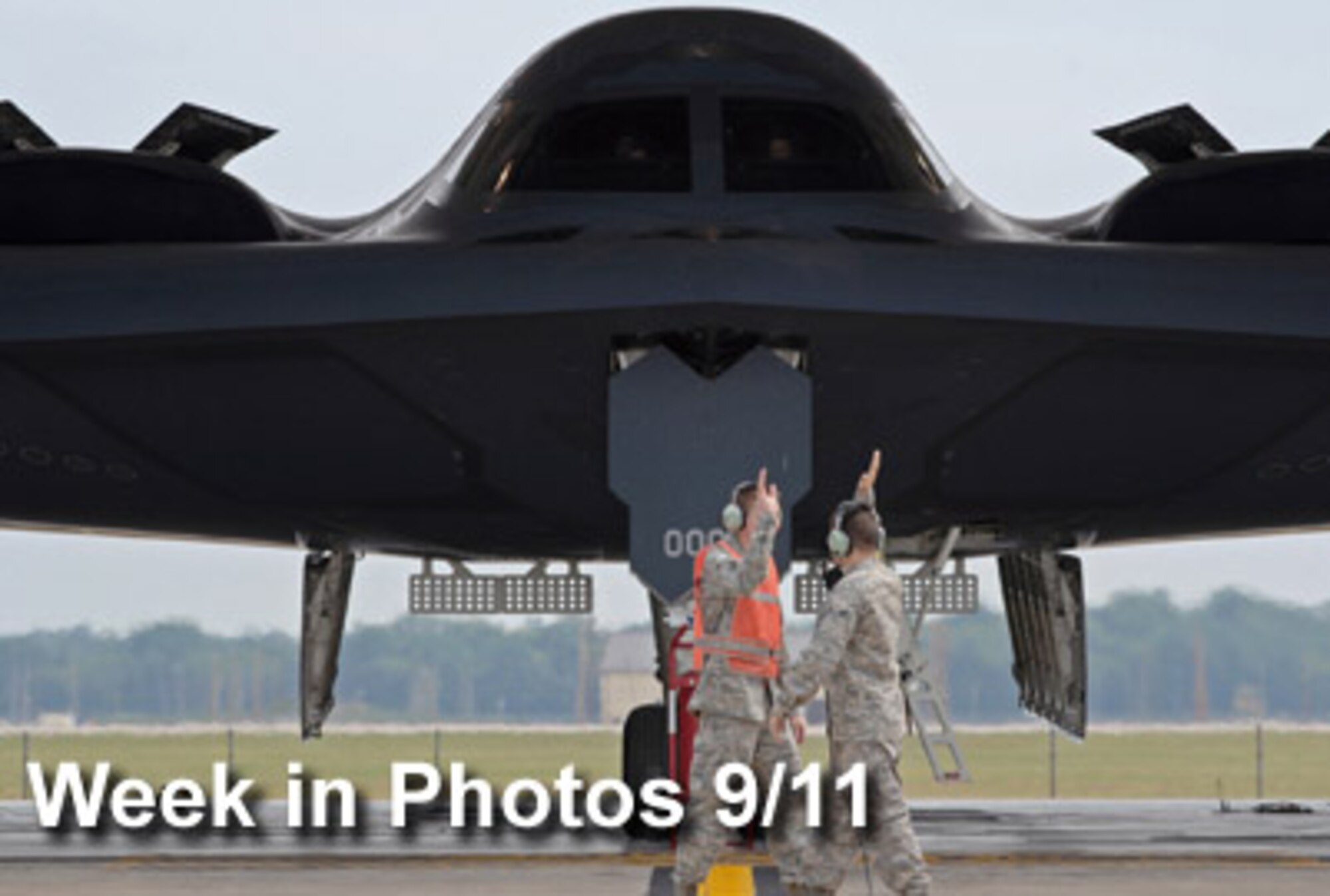 Air Force Week in Photos for Sept.11 highlights photos from around the Air Force. In this photo by Senior Airman Kenny Holston, Airmen 1st Class Patrick Holter (left) and Patrick Dixon start the high-five salute as they prepare to launch the first B-2 Spirit of the day Sept. 8, 2009, on the Whiteman Air Force Base, Mo., flightline. (U.S. Air Force photo illustration)
