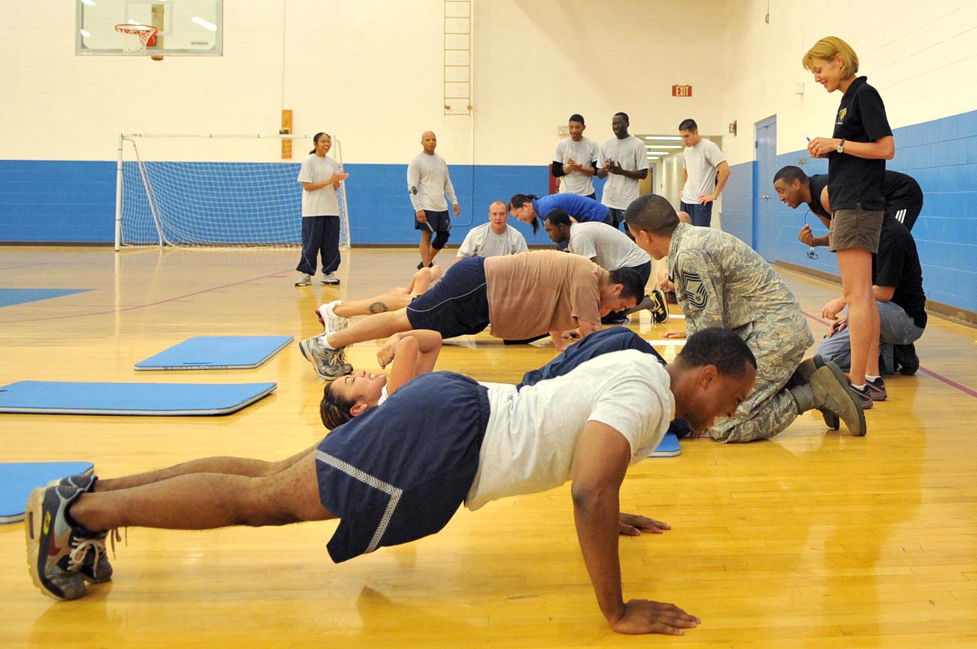 CANNON AIR FORCE BASE, N.M. - Thirty-six Airmen compete against each other in the Chief's Group Push-Up/Sit-Up competition and fundraiser here Sep. 10. Prizes will be awarded for most push-ups and sit-ups in each age group, most pledges collected, and unit with the most participants.  A portion of the proceeds will be donated to the Combined Federal Campaign.  (U.S. Air Force photo by Staff Sgt. Heather R. Redman)  