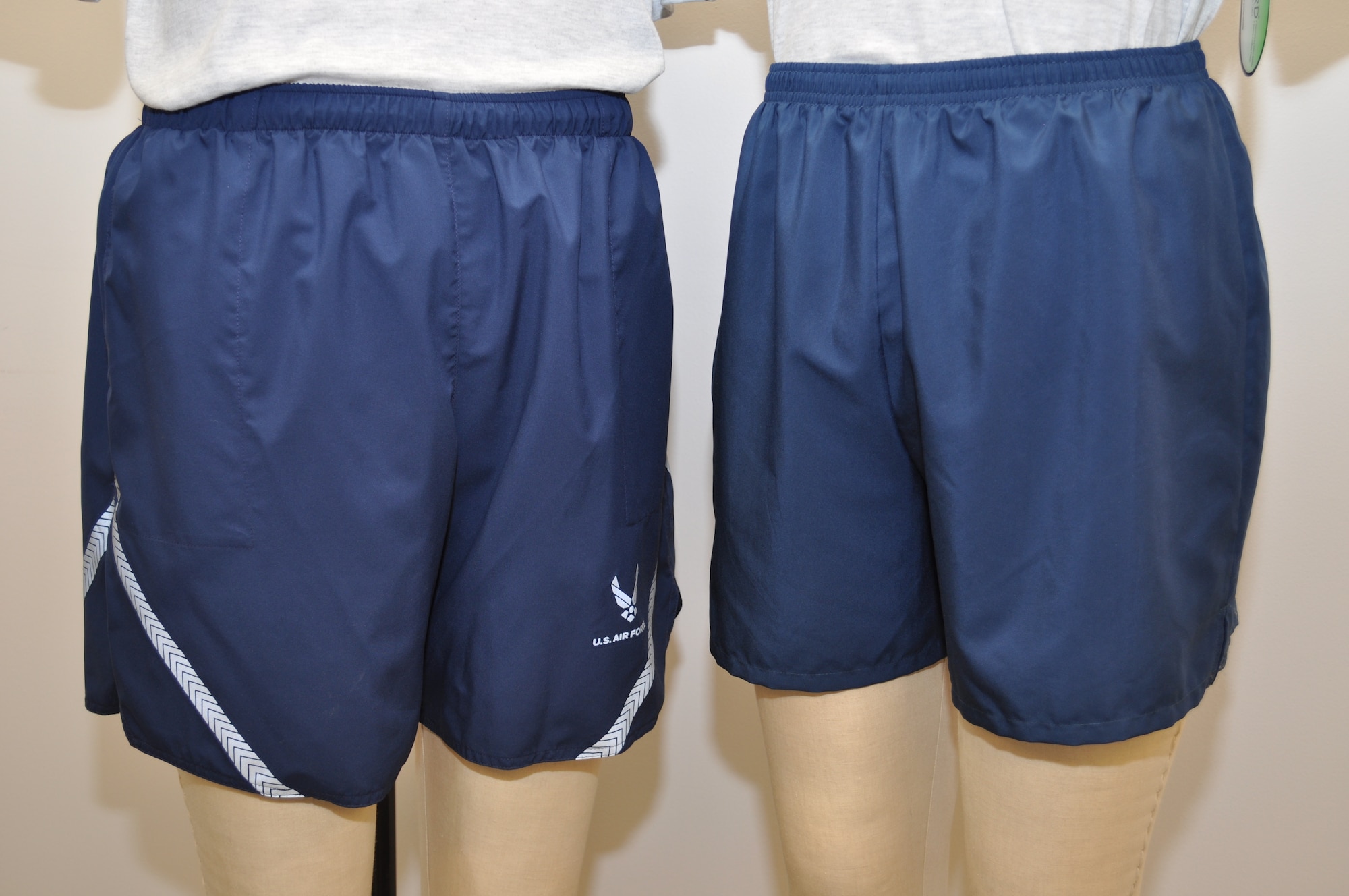 Air Force officials at Wright-Patterson Air Force Base, Ohio will unveil new lightweight running shorts this month in time for the Air Force Marathon Sept. 19. The new shorts (at right) feature a durable, quick-drying nylon shell with polyester brief for moisture management, a 4.5 inch inseam, drawstring waist, and oversized inside back key pocket. They are the same shade of blue as the previous physical training uniform shorts (left), without the Air Force emblem or reflective material. They will be available for sale only at AAFES Military Clothing Sales Stores. (Air Force photo/Brad Jessmer).
