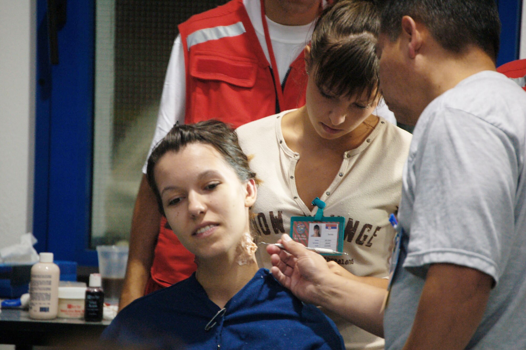 Marija Gocic tilts her head as Senior Master Sgt. Juan Gomez, 86th Medical Group from Ramstein Air Base, Germany, applies moulage to her neck. Ms. Gocic was one of 50 students from the school who participated as a mock patient during the live exercise portion of the military medical training exercise in Central and Eastern Europe, or MEDCEUR 2009 in Nis, Serbia. Ms. Gocic is a medical student at Dr. Milenko Hadzic Medical School here. (U.S. Air Force photo/Senior Airman Kali L. Gradishar) 