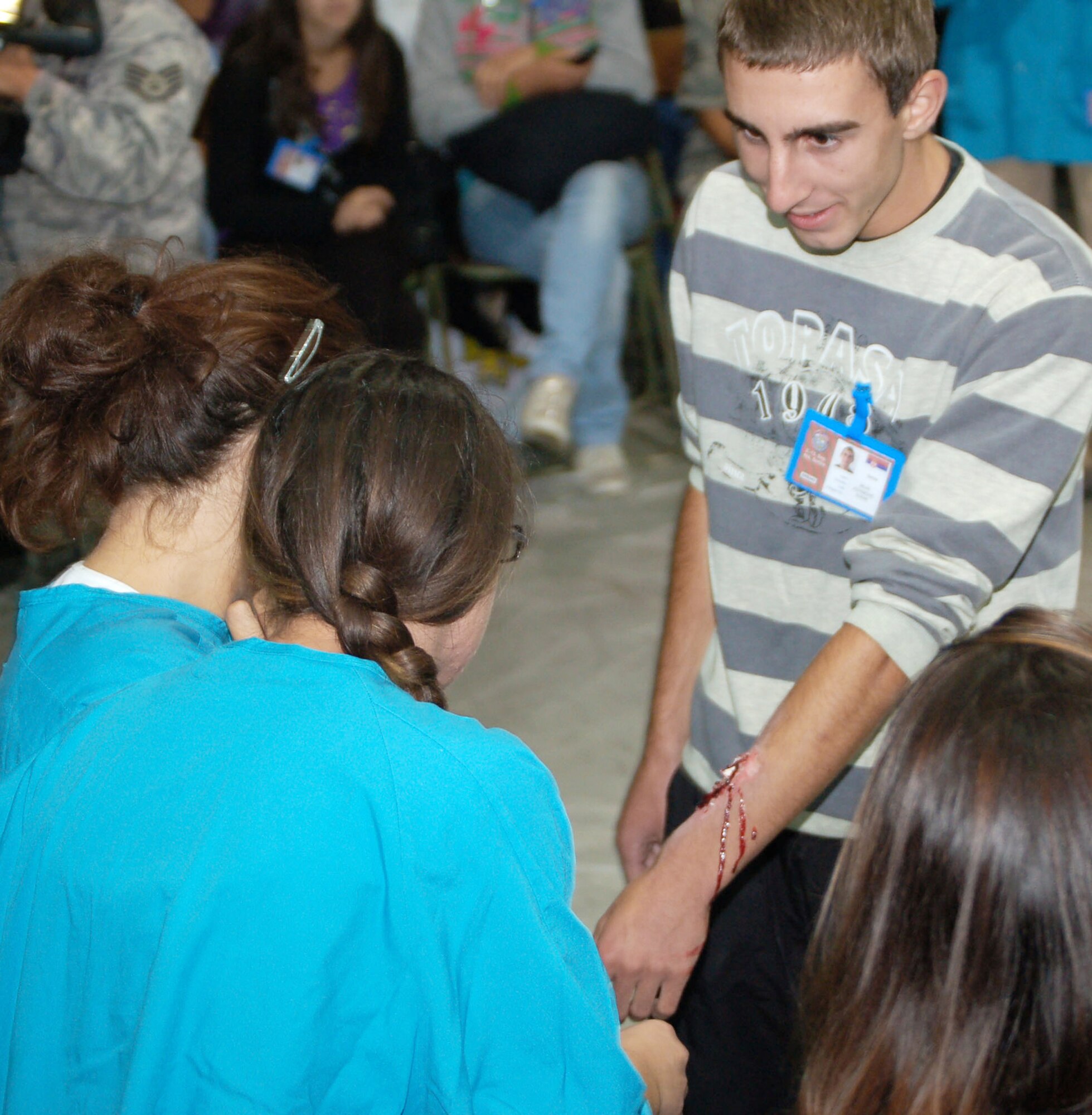 Milan Jovanovic shows off a mock open fracture to his classmates Sept. 8 during moulage training conducted by Airmen of the 86th Medical Group from Ramstein Air Base, Germany, in Nis, Serbia. Fifty students from the school participated as "casualties" in the live exercise portion of the military medical training exercise in Central and Eastern Europe, or MEDCEUR 2009. Jovanovic is a medical student at Dr. Milenko Hadzic Medical School here. (U.S. Air Force photo/Senior Airman Kali L. Gradishar) 