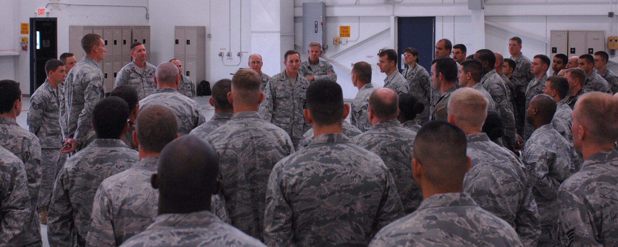 CANNON AIR FORCE BASE, N.M.-- Tech. Sgt. Geoffrey Alexander, 27th Special Operations Maintenence Group, Staff Sgt. Chad Tew, 27 SOMXG, and Staff Sgt. Jerome Latham, 27 SOMXG, are congradulated by Col. Stephen Clark, 27th Special Operations Wing commander, at hanger 126 Sep 3. The Airmen cut the home station check process time from 7 days to 3.5 days, saving the Air Force 400 man hours and $13,829.  (U.S. Air Force photo by Airman 1st Class James Bell)